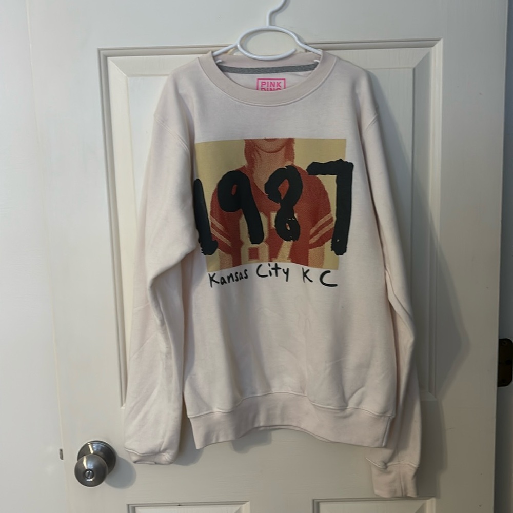 This is a Taylor Swift + Travis Kelce crew neck